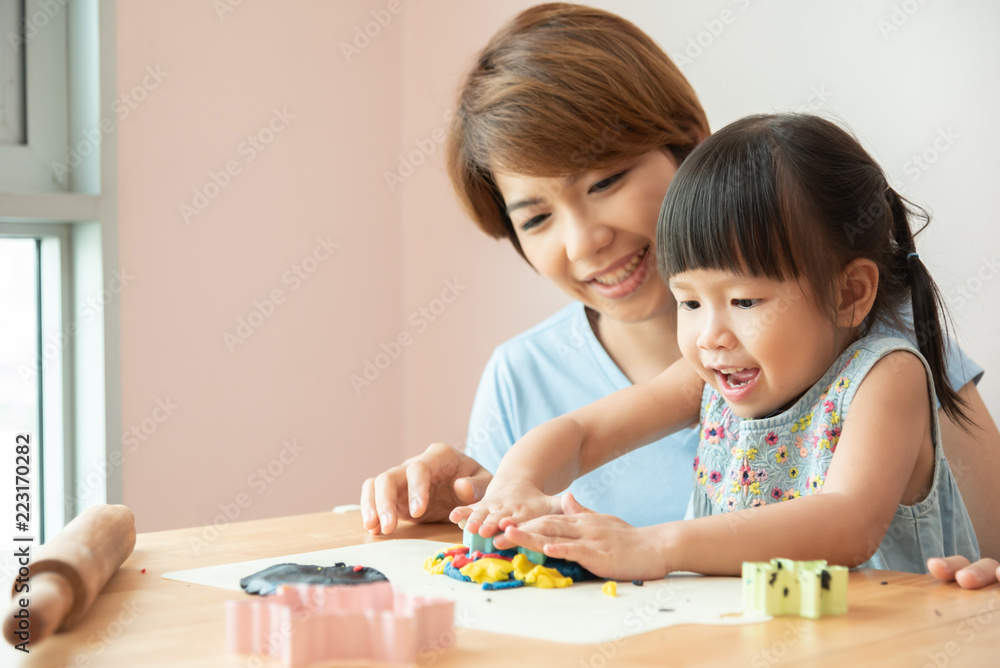 Happy mother and kid preparing the colorful dough. Happy mother and kid preparing the colorful dough.