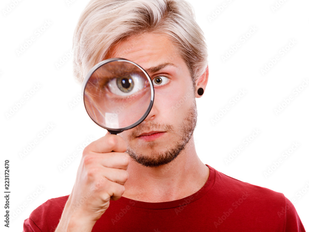 man holds on eye magnifying glass looking through loupe man holds on eye magnifying glass looking through loupe