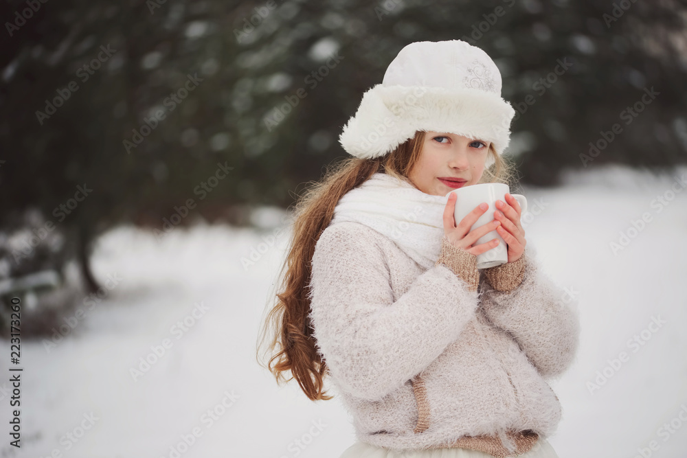 Obraz premium little happy beautiful girl in winter forest