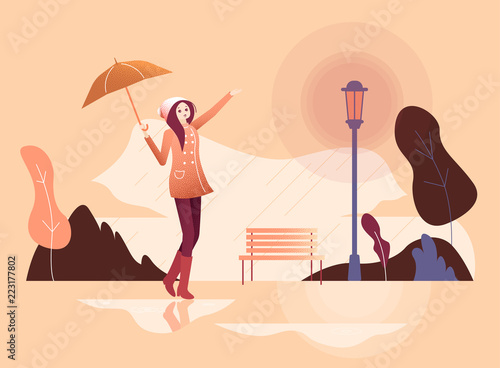 Girl with umbrella walks in the rain in park.