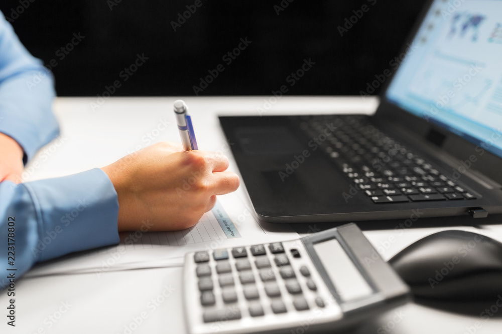 business, accounting, deadline and overwork concept - close up of businesswoman with tax form, laptop computer and calculator working at night office business, accounting, deadline and overwork concept - close up of businesswoman with tax form, laptop computer and calculator working at night office