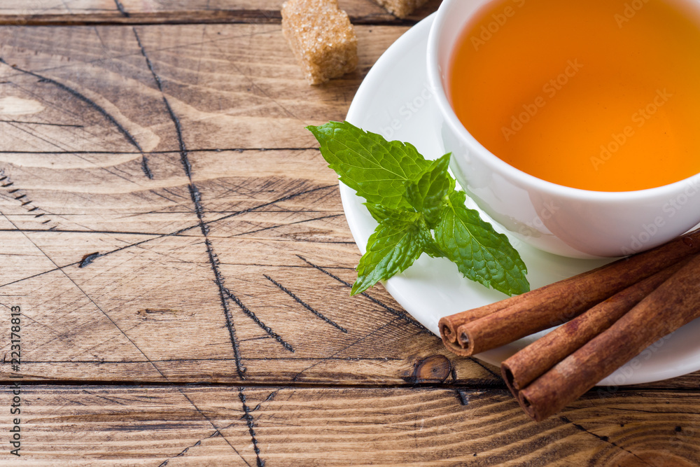 Cup of hot tea with mint and brown sugar on a wooden table Copy sapce Cup of hot tea with mint and brown sugar on a wooden table Copy sapce
