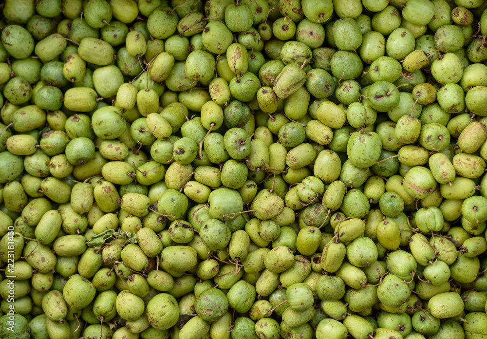 Green and unripe walnut in market. Green and unripe walnut in market.
