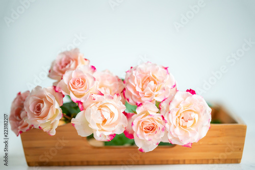 pink roses on a wooden tray © Vera