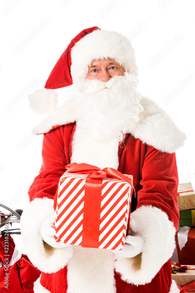 santa claus holding striped gift box and looking at camera isolated on white santa claus holding striped gift box and looking at camera isolated on white