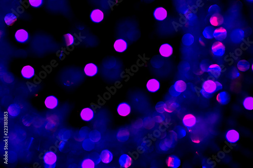 Abstract blue violet christmas bokeh lights isolated on black background. Christmas tree light background. New year decorations. Abstract lights on black. Winter theme.