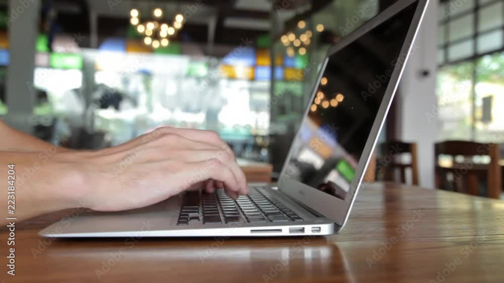 Man hands working on laptop computer in cafe Man hands working on laptop computer in cafe