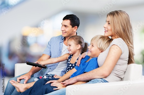 Beautiful smiling Lovely family watching tv on
