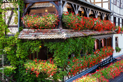 half timbered house with balconies full of flowers in Strasbourg, France