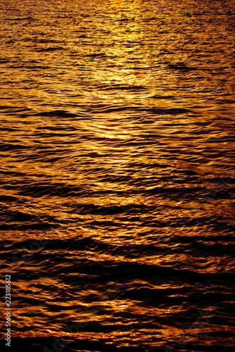 the sun is reflected in the waves of the sea