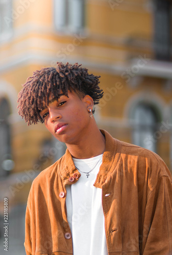 Hispanic black young man model with afro curly hair urban portrait