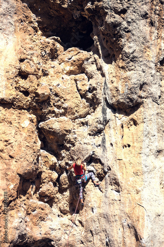 A woman climbs the rock. © zhukovvvlad