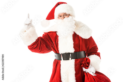 santa claus pointing up while looking at camera isolated on white