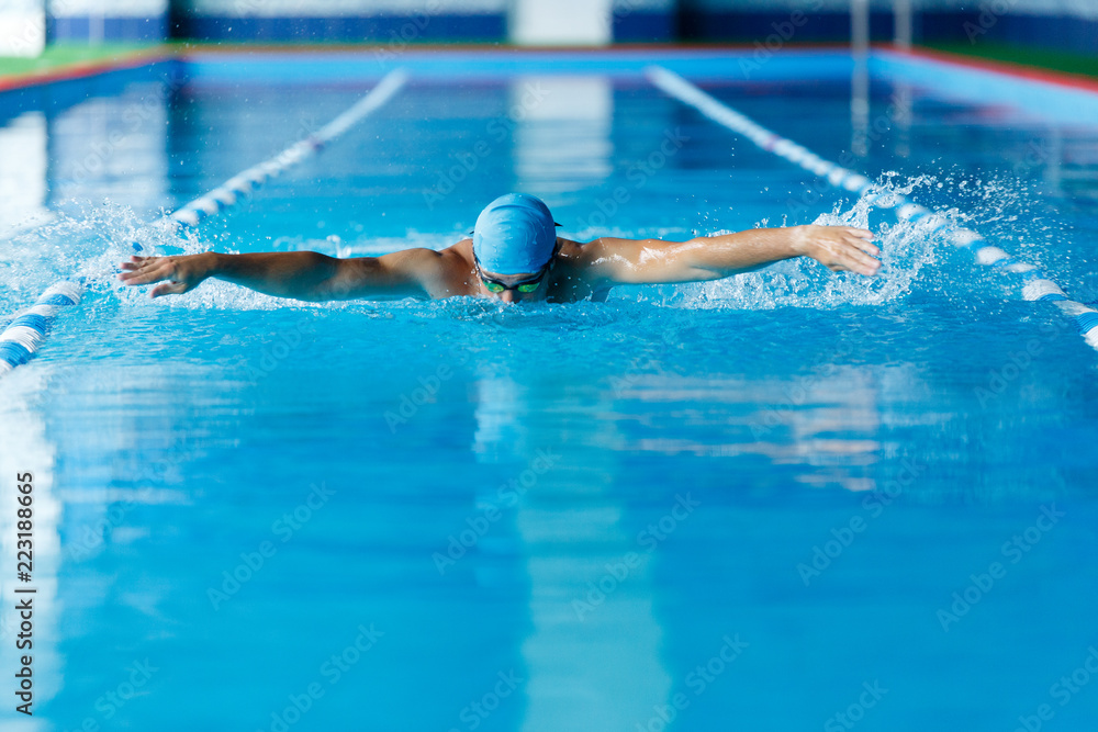 Image of sportsman swimming along path in pool