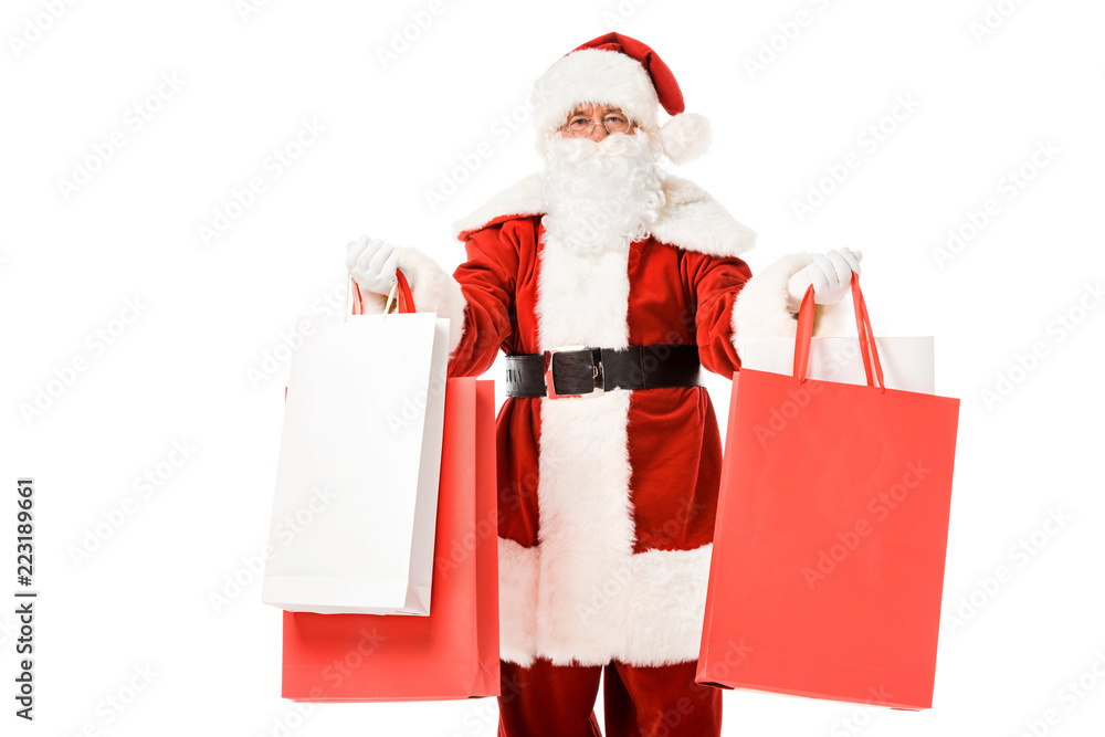 santa claus standing with paper bags in hands and looking at camera isolated on white santa claus standing with paper bags in hands and looking at camera isolated on white