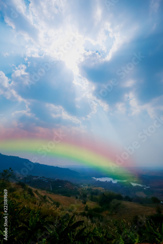 Landscape  mountain hill sun beam and lighting blue sky with rainbow. beautiful nature background and wallpaper. 