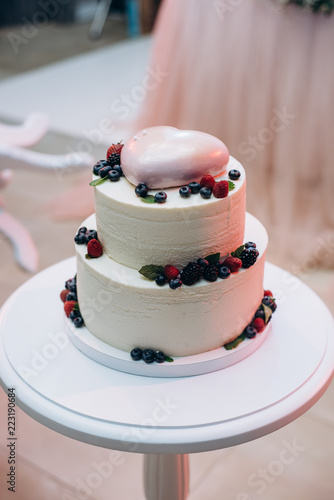 Wedding or birthday cake with berries. Sweet pie on banquet in restaurant. 