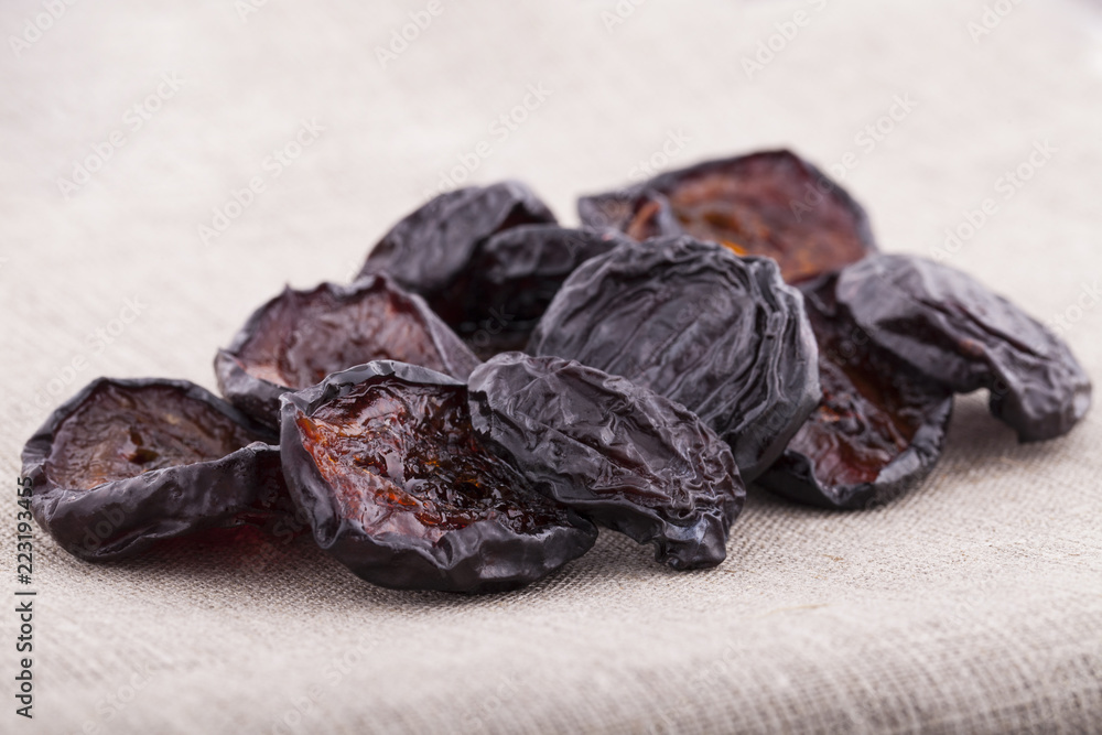 Dried plums on textile background Dried plums on textile background