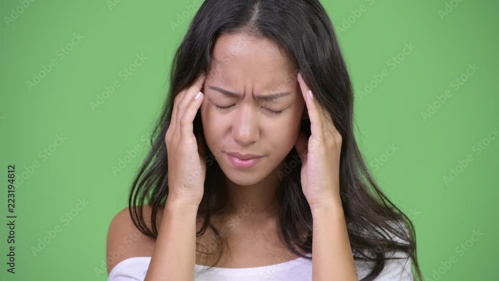 Young stressed multi-ethnic woman having headache Young stressed multi-ethnic woman having headache