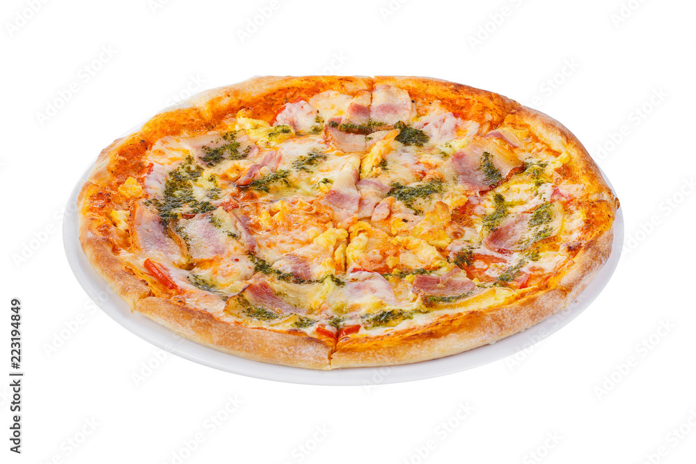 Pizza with sauce, pesto, basil, ham, bacon, whole round, cut into pieces, on a white isolated background. Fast food in a pizzeria, a floury cheese product. Side view