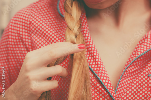 Woman doing braid on blonde hair