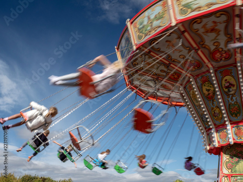 The motion of people on a fairground ride on a summer's day