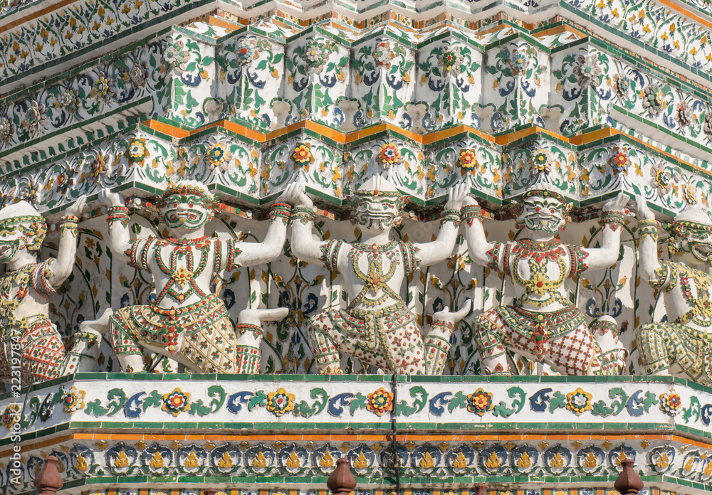 Closeup of warrior statues carved in stone in Wat Arun, Bangkok