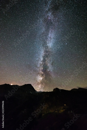 Milky way galaxy stars over the Alps, Mars and Jupiter planet, snowcapped mountain range, astro night sky stargazing
