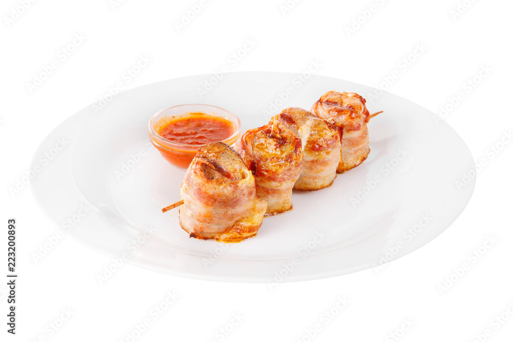 Shish kebab, beef, lamb, pork, chicken in bacon grilled meat, barbecue, without garnish on a plate, isolated on white background, ketchup, tomato red sauce. Side view For the menu