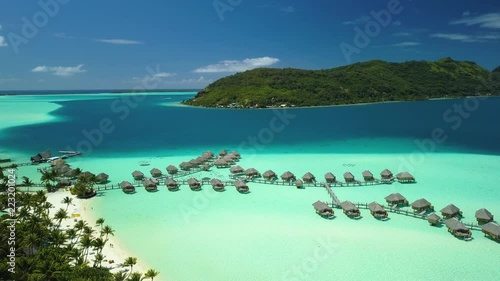 Wallpaper Mural Aerial footage from a drone of luxury overwater villas with palm trees, blue lagoon, white sandy beach and Otemanu mountain at Bora Bora island, Tahiti, French Polynesia (Bora Bora Aerial)
 Torontodigital.ca