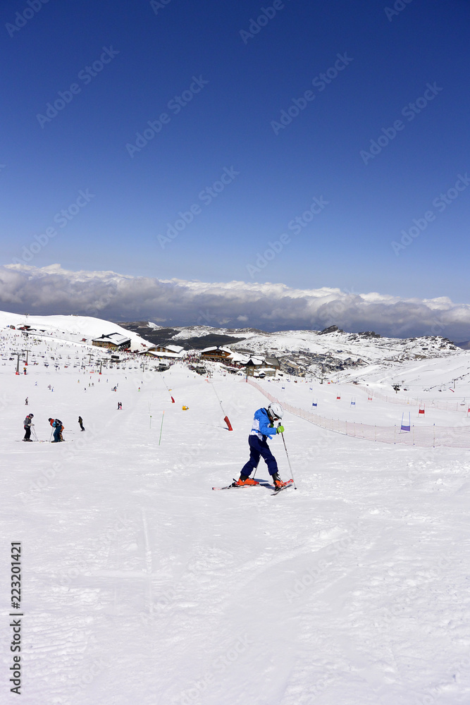 On the snow-capped peaks of  the mountain Sierra Nevada skiers and snowboarders