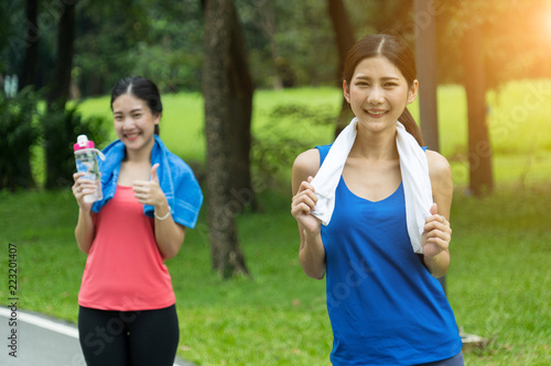 Portrait of girls couple go exercise in a park and feeling friendly