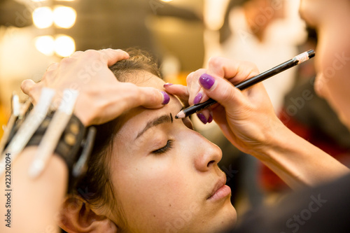 Young women doing makeup , old-fashioned. Backstage.