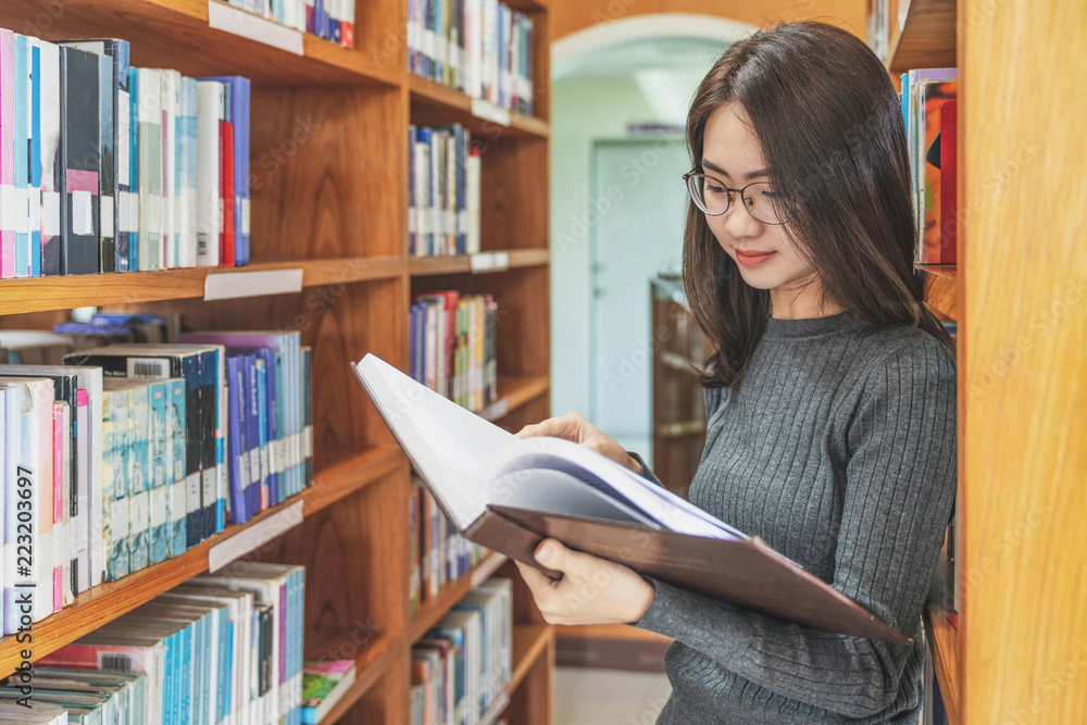 Back to school education knowledge college university concept, Beautiful female college student holding her books smiling happily standing in library, Learning and education concept Back to school education knowledge college university concept, Beautiful female college student holding her books smiling happily standing in library, Learning and education concept