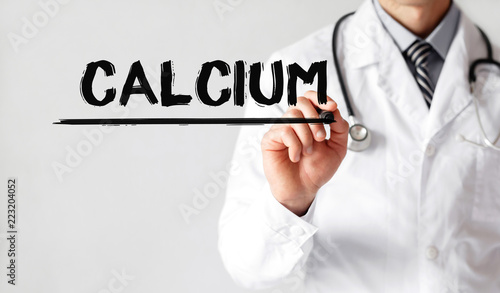 Doctor writing word CALCIUM with marker, Medical concept