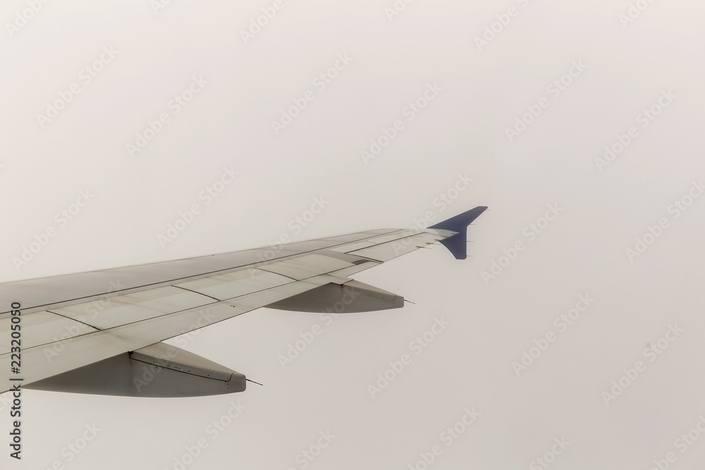 Looking through window aircraft during flight in wing with a blue sky Looking through window aircraft during flight in wing with a blue sky