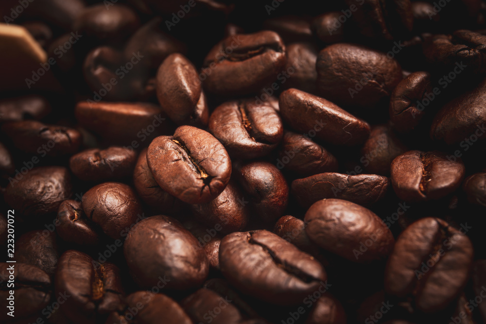 Medium roasted organic coffee beans close up. Processed in vintage and worm tone color. Medium roasted organic coffee beans close up. Processed in vintage and worm tone color.