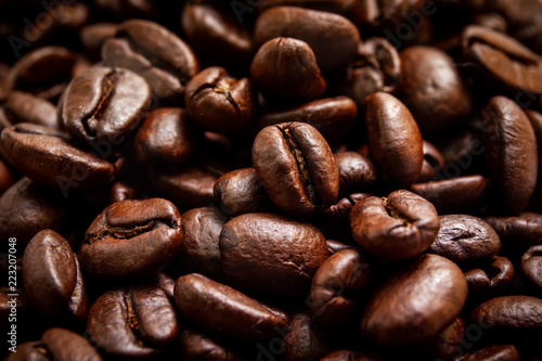 Medium roasted organic coffee beans close up. Processed in vintage and worm tone color.