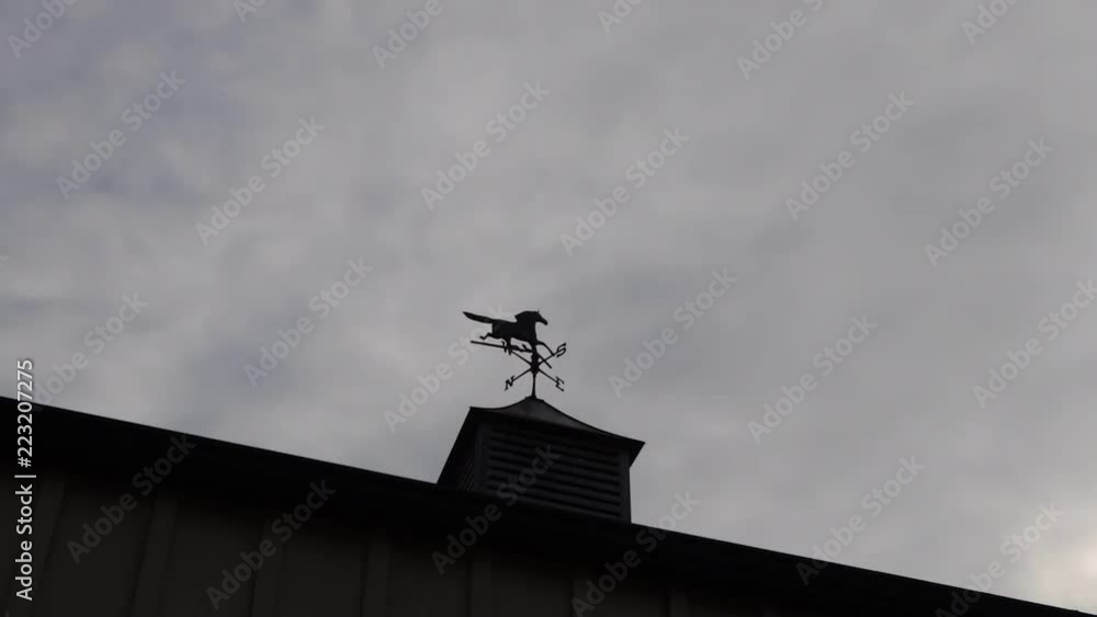 Timelapse of clouds moving over a silhouetted weather vain Timelapse of clouds moving over a silhouetted weather vain