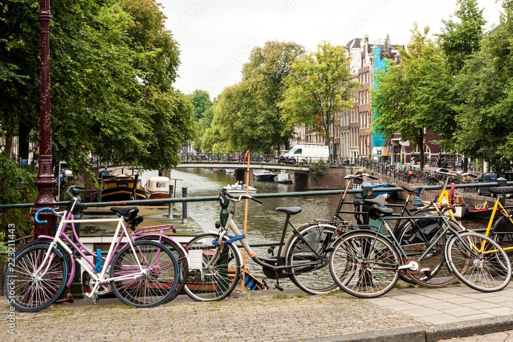 Bicycles Parked on a Bridge over a Canal