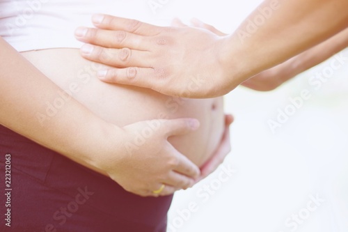 Wallpaper Mural The husband holds the pregnant wife's belly. New mom Pregnant woman in white underwear. Young woman expecting a baby Stand in the outdoors. Torontodigital.ca