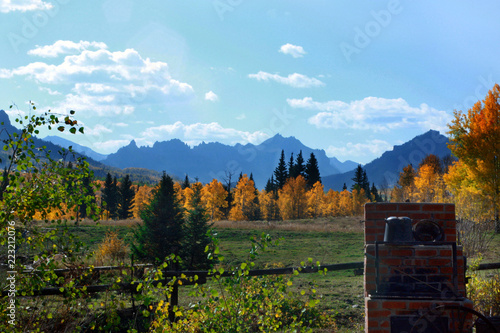 An outdoor brick oven in a back yard with an amazing view of mountains and trees in fall colors photo
