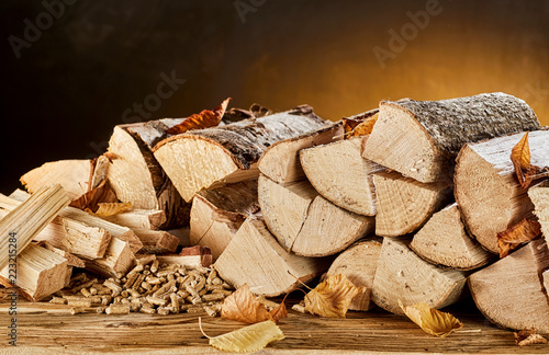 Konstfotografi Stack of wood logs sitting on top of table
