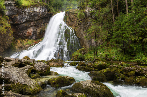 Beautiful view of famous Gollinger Wasserfall with mossy rocks and green trees on a moody in springtime, Golling, Salzburger Land, Austria © radu79