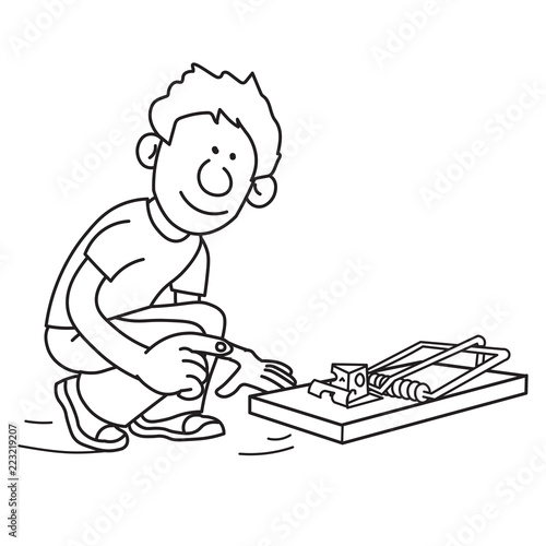 Young boy setting up a mouse trap with a piece of cheese inside watching looking carefully