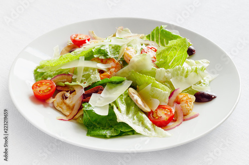 romaine salad with shrimps, champingons, tomatoes, olives, and onion dressed with modena vinegar and olive oil and sprinkled with parmesan