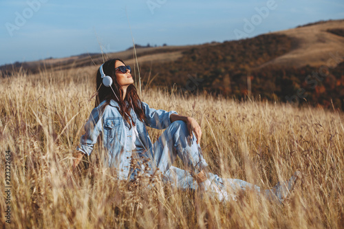 Young woman enjoys the sun in the meadow