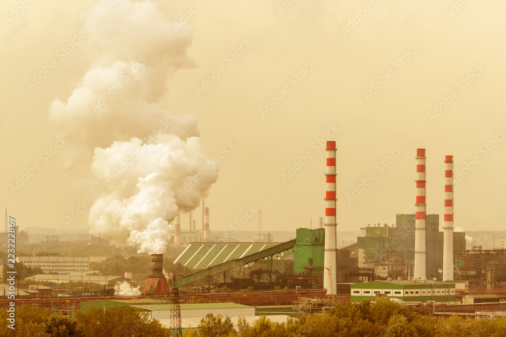Coal processing plant operates on the river bank. Smoke from the pipes pollutes the atmosphere of the city. Concept of pollution of the environment, emissions into water resources. Industrial landscap Coal processing plant operates on the river bank. Smoke from the pipes pollutes the atmosphere of the city. Concept of pollution of the environment, emissions into water resources. Industrial landscap