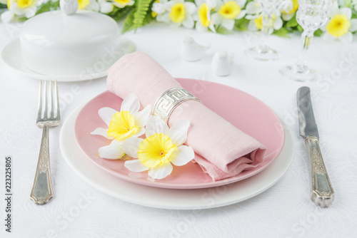 Porcelain plates, silverware and spring flowers