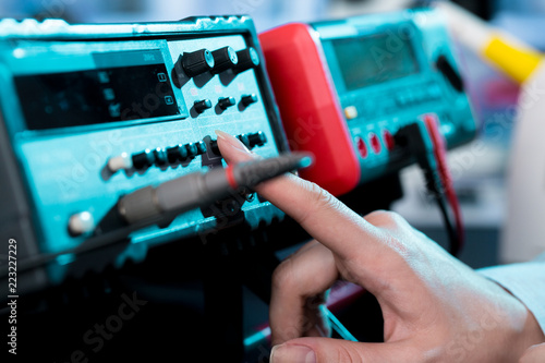 Engineer hand use Electrical equipment (Insulation tester) for measure i circuit.
